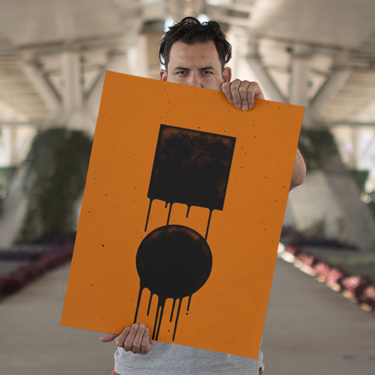Person holding a large orange sign with a black circle and lines in an outdoor setting.